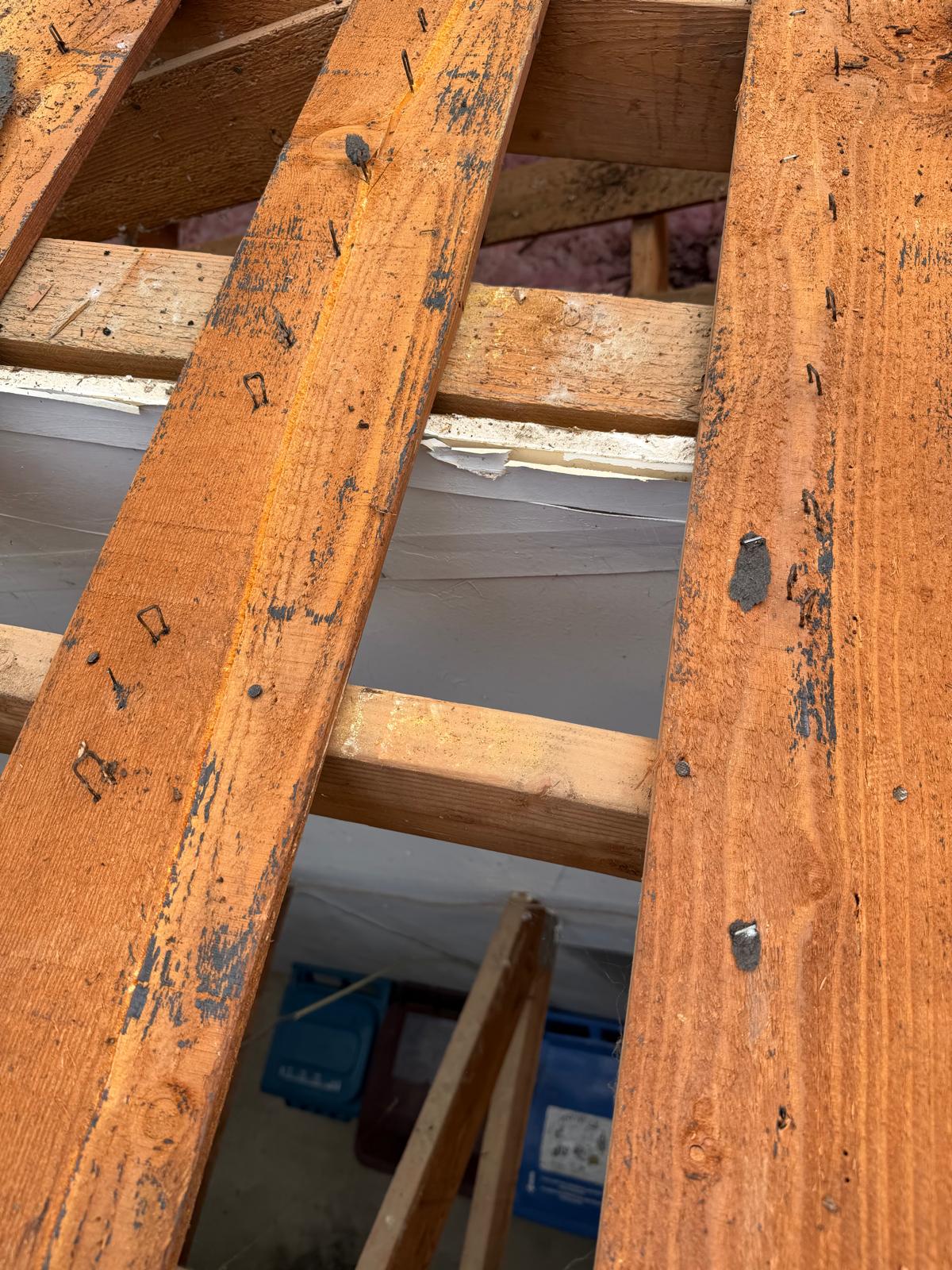 Daylight visible through openings in a residential attic roof